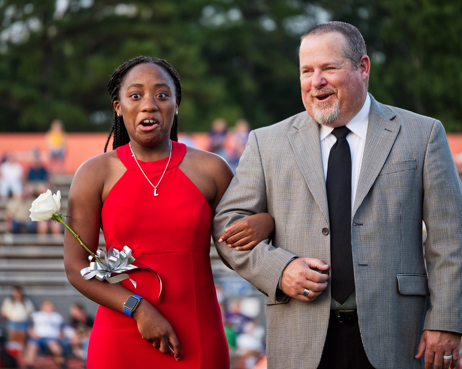 Lovely Wright is shocked to hear her name announced as homecoming queen; she is escorted by Kendall Banks.